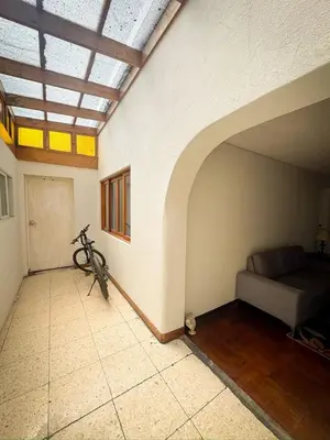 a room with a bed and a bike in it at Miraflores, habitación Triple en apartamento compartido in Lima