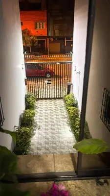 a view of a walkway with a fence and flowers at Miraflores, habitación Triple en apartamento compartido in Lima