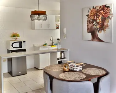 a kitchen with a table and a counter top at Lindo depa cerca a huacachina in Ica