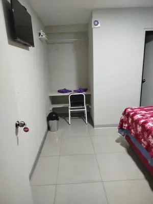 a room with a bed and a table and a chair at Hostal San Ignacio Monterrico in Lima