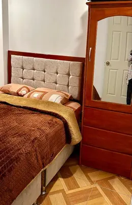 a bedroom with a bed with a mirror and a dresser at Tampumachay in Cusco