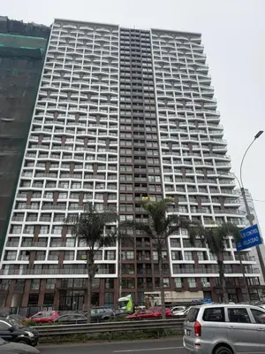 a large building with palm trees in front of it at casahotel lof javier prado in Lima