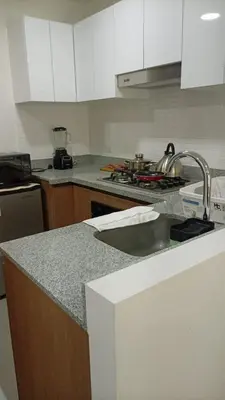 a kitchen with a sink and a counter top at casahotel lof javier prado in Lima