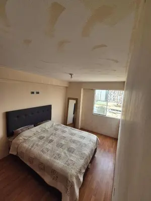 a bedroom with a bed and a large window at Luna Room in Lima