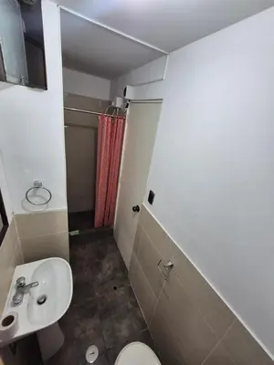 a bathroom with a toilet and a sink at Luna Room in Lima