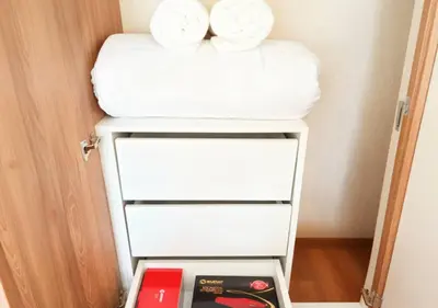 a stack of towels on top of a refrigerator at E 24h Urban Comfort 1BR 302 in Lima