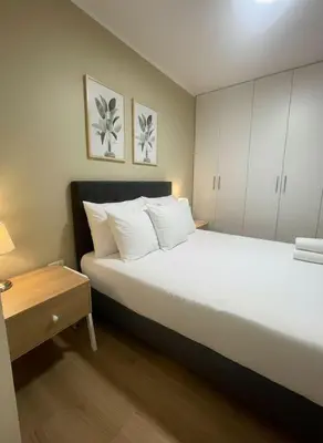 a bedroom with a large white bed and a table at E Magdalena Costanera Access Wifi Pro 2B 204 in Lima