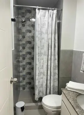 a bathroom with a shower curtain and a toilet at E Magdalena Costanera Access Wifi Pro 2B 204 in Lima