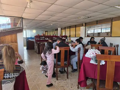 a group of people sitting at tables in a restaurant at Inkas Hotel Cusco in Cusco