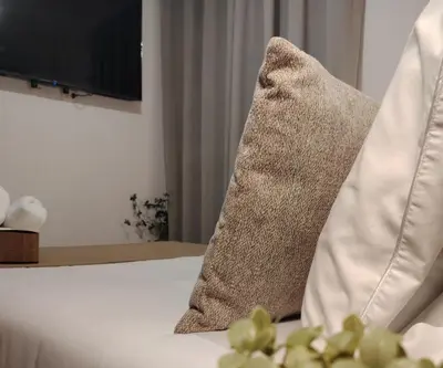 a pillow sitting on top of a bed at C&S Apartment Fierro in Cusco
