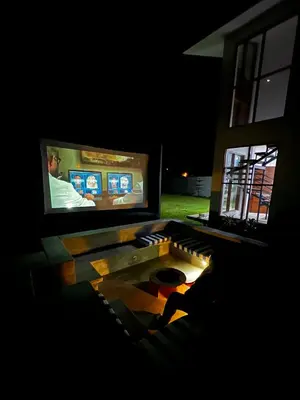 a room with two television screens and a coffee table at Casa de Campo Privada en Cieneguilla con Piscina y Cine in Cieneguilla
