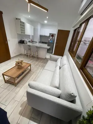 a living room with a couch and a table at Penthouse con Vista al Mar in Lima