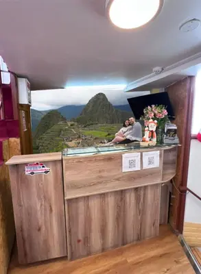 a restaurant counter with a mural of a mountain at Pakari wasi inn in Cusco