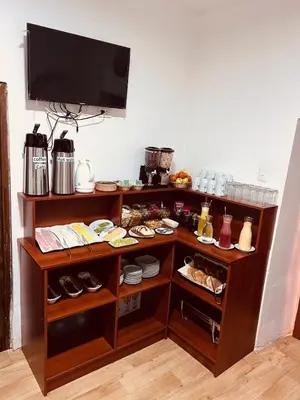 a shelf with food and a tv on a wall at Pakari wasi inn in Cusco