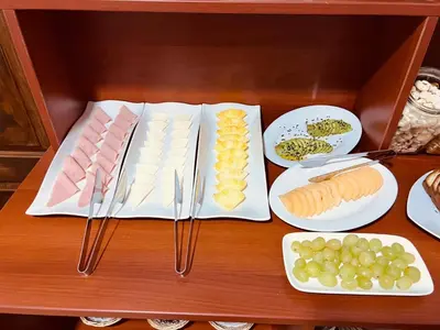 a wooden table with plates of food on it at Pakari wasi inn in Cusco