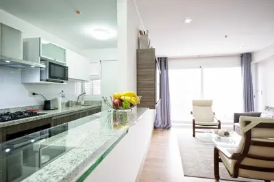a kitchen with a counter with a bowl of fruit on it at Upper Pardo Apartments in Lima
