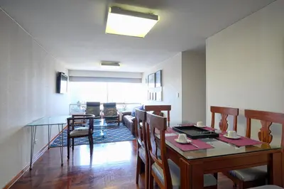 a dining room with a table and chairs at Guernica Apartments in Lima