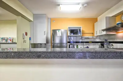 a large kitchen with a stainless steel refrigerator at La Masia Apartments in Lima