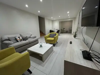 a living room with a couch and chairs and a tv at 2-Bedroom Apartment in Magdalena del Mar in Lima