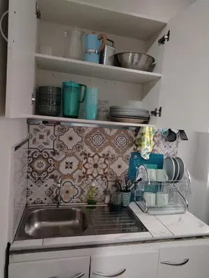 a kitchen with a sink and a tile wall at loft Inti in Cusco
