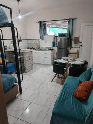 a kitchen and a living room with a bed and a table at loft Inti in Cusco