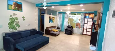a living room with a blue couch and a chair at Casa San Ramón in San Ramón