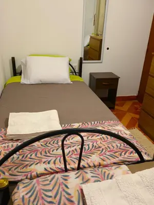 a bedroom with two beds and a pillow on top at Sumaq Tika in Cusco