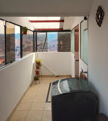 a room with a view of a city from a building at Hanan Pacha in Cusco