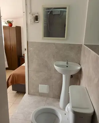 a bathroom with a sink and a toilet and a mirror at Hanan Pacha in Cusco