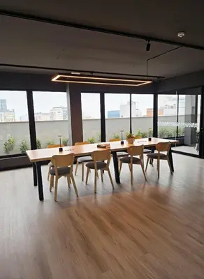 a dining room with tables and chairs in an office at Apartment suite in the heart of Miraflores! in Lima