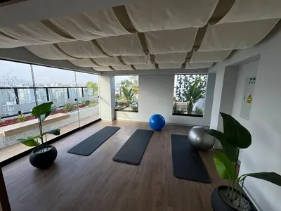 a yoga room with blue mats and large windows at Cozy bedroom in Miraflores with rooftop pool in Lima