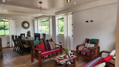 a living room with a couch and chairs and a table at Chakana Wasi in Calca
