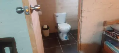 a bathroom with a white toilet in a room at Cozy Rural House in Apata - Jauja