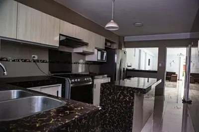 a kitchen with a sink and a stove at Cieneguilla Casa in Cieneguilla