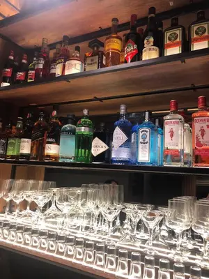 a shelf filled with glasses and bottles of alcohol at Hotel Zaniah in Huancayo
