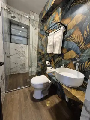 a bathroom with a toilet and a sink and a shower at Hotel Zaniah in Huancayo