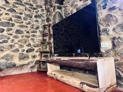 a tv sitting on top of a stone wall at Stone house in Ollantaytambo in Ollantaytambo