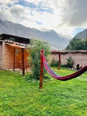 a hammock in front of a building in a yard at Stone house in Ollantaytambo in Ollantaytambo
