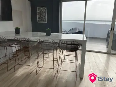 a dining room table with chairs and a counter top at iStay Acogedor Loft Piscina BBQ Gym Bicicleta in Lima