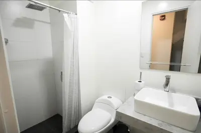 a white bathroom with a sink and a shower at iStay Acogedor Loft Piscina BBQ Gym Bicicleta in Lima