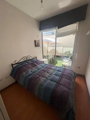 a bedroom with a bed and a large window at Comfortable apartment in downtown area - 3 bedrooms in Lima