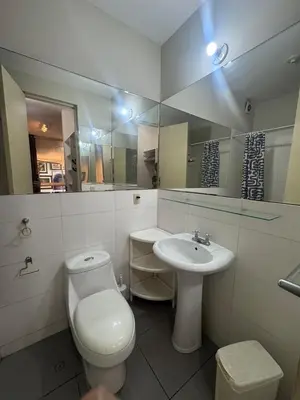 a white bathroom with a toilet and a sink at Comfortable apartment in downtown area - 3 bedrooms in Lima