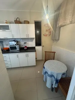 a small kitchen with a table and a microwave at Comfortable apartment in downtown area - 3 bedrooms in Lima