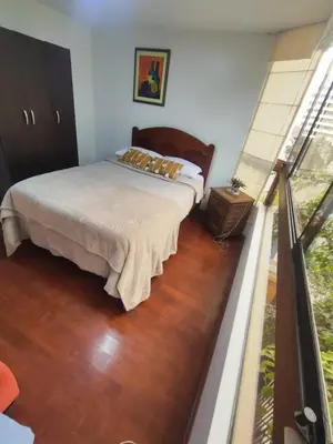 a bedroom with a bed and a window at Céntrica habitación con vistas Larcomar in Lima