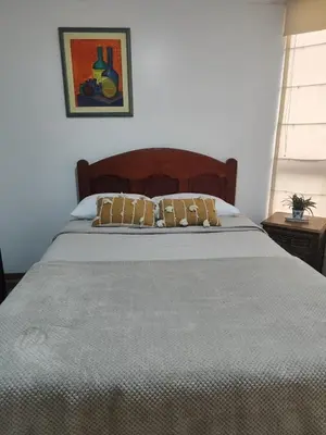 a bed with two pillows on it in a bedroom at Céntrica habitación con vistas Larcomar in Lima