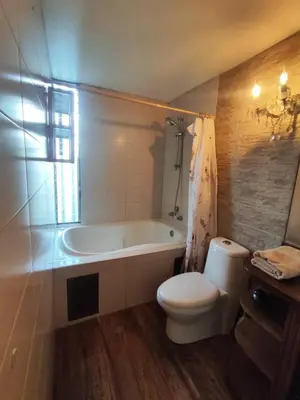 a bathroom with a tub and a toilet and a sink at Amplia y céntrica habitación con vistas Larcomar in Lima