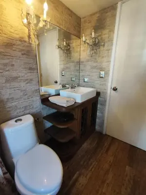 a bathroom with a toilet and a sink and a mirror at Amplia y céntrica habitación con vistas Larcomar in Lima