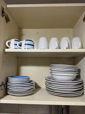 a shelf filled with plates and bowls and dishes at Departamento en Cusco NAIRA in Cusco