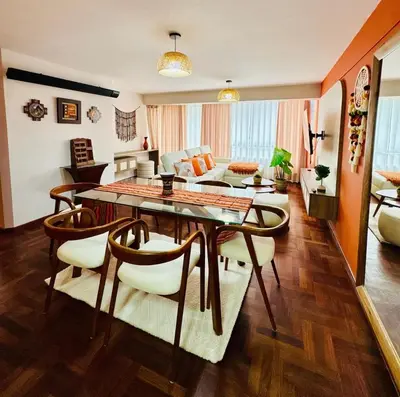 a living room with a table and chairs at Departamento en Cusco NAIRA in Cusco