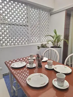 a wooden table with plates and cups on it at Historic Quinta, Heart of Miraflores, 2 Bedroom Apartment in Lima